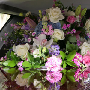 closeup shot of a funeral casket in a hearse or chapel or burial at cemetery